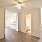 bedroom with ceiling fan and lighting, access to bathroom and walk-in closet