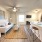 living room with ceiling fan and light fixture, open to kitchen and dining area