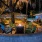 lighted fire pit at night surrounded by chairs